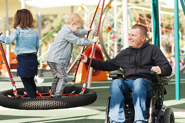 person in wheelchair at a playground